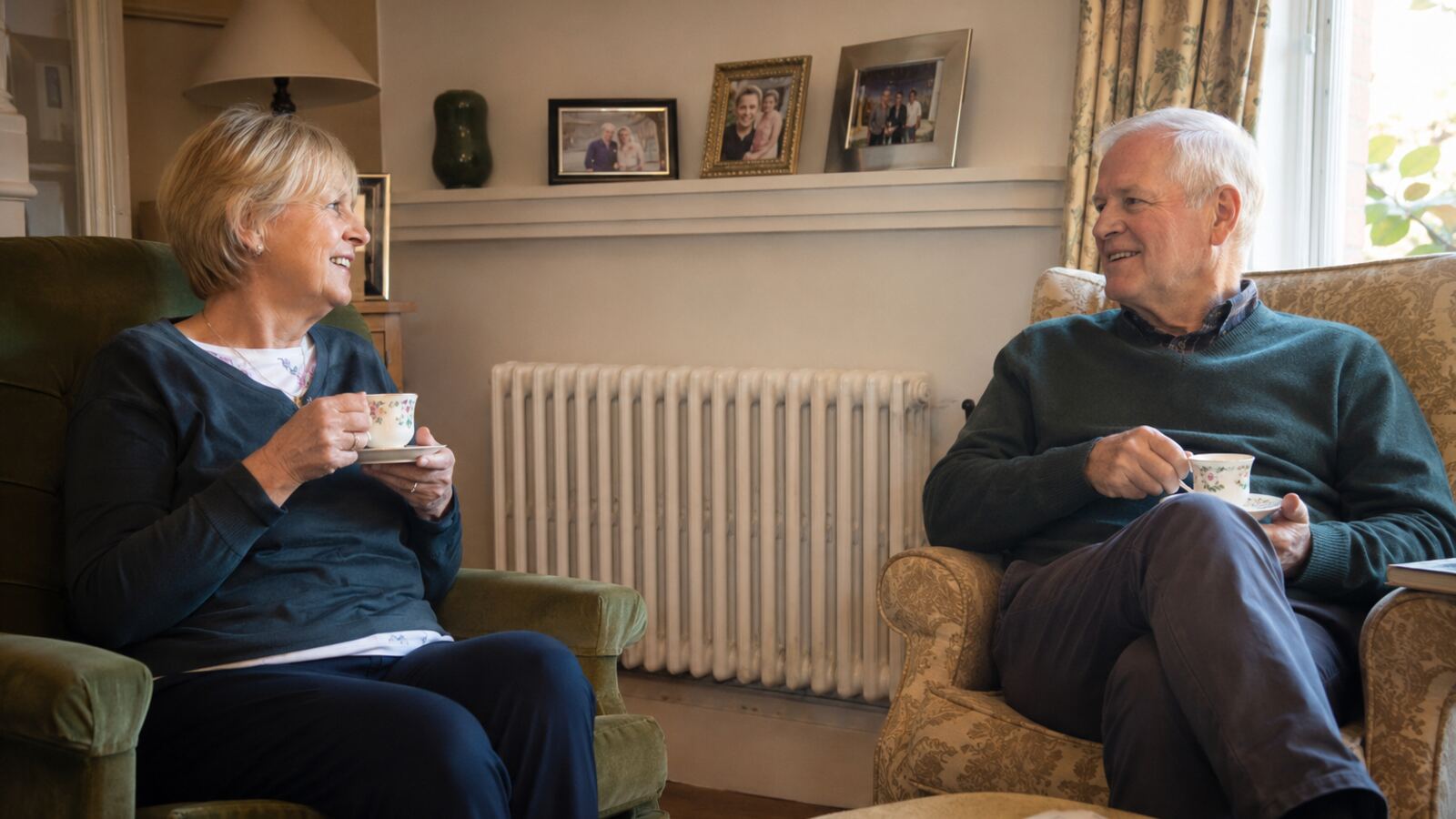 Older couple enjoying tea together beside a warm radiator